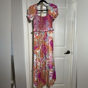 RAYA MAUI dress short sleeve size small with smocking to enhance the figure.